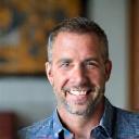 A portrait of David Macdonald, a graphic designer, smiling warmly.